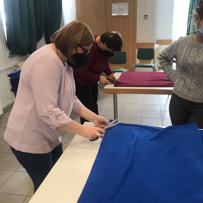 Members and friends of The Church of Jesus Christ of Latter-day Saints help prepare blankets for refugees arriving at the Romanian eastern border.