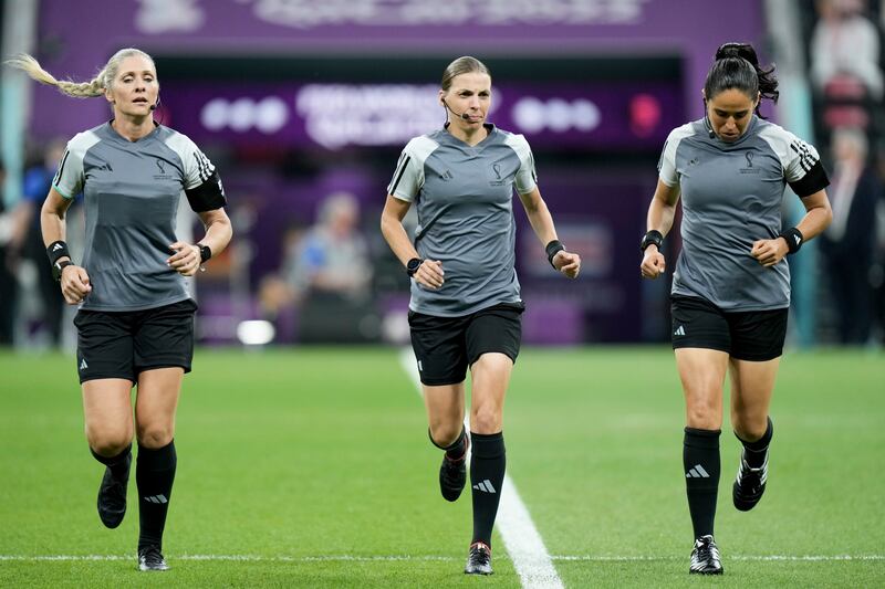 Referee Stephanie Frappart and assistant referees Neuza Back and Karen Diaz warm up at the Al Bayt Stadium in Al Khor, Qatar.