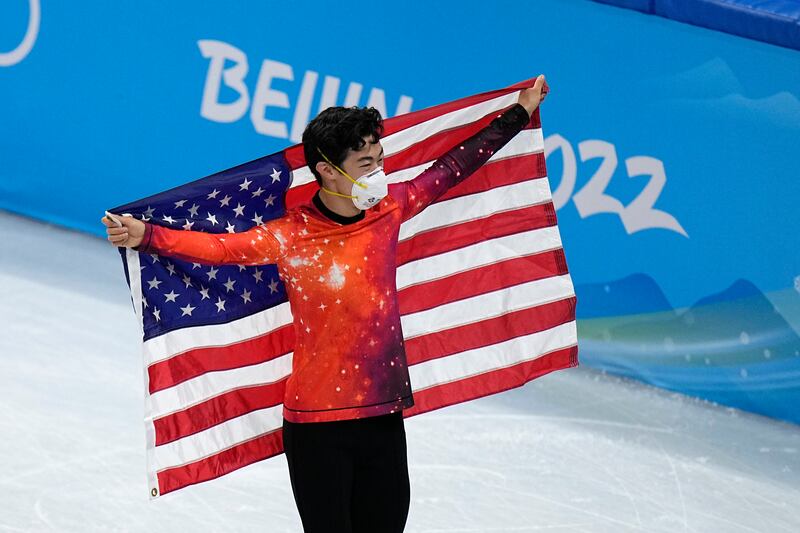 Gold medalist Nathan Chen, of the United States, poses after the men’s free skate program during the figure skating event at the 2022 Winter Olympics
