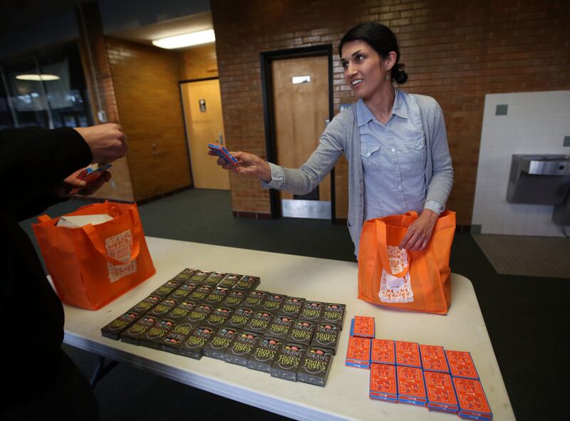 Jess Bigler, prevention specialist with Davis Behavioral Health, hands out conversation cards for parents and children after a showing of the documentary film "Angst" at Clearfield High School in Clearfield on Monday, April 30, 2018.