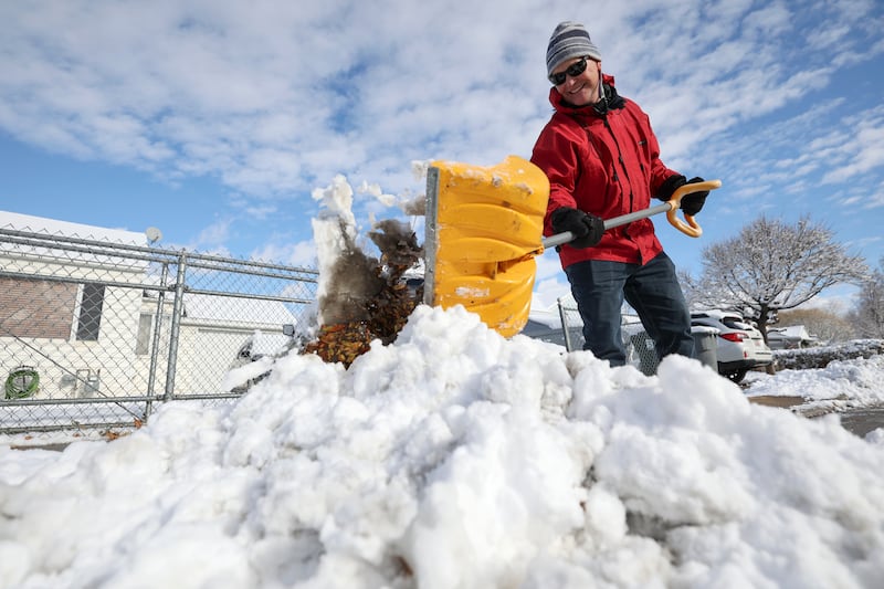 Jeff Harris shovels his neighbor’s driveway after a snowstorm.