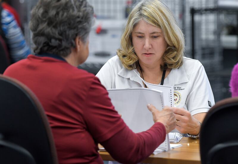 Victoria Bodily, left, and Shelly Jackson, with the Utah lieutenant governor’s office, look over ballots during an election recount on Dec. 13, 2023, in Logan.