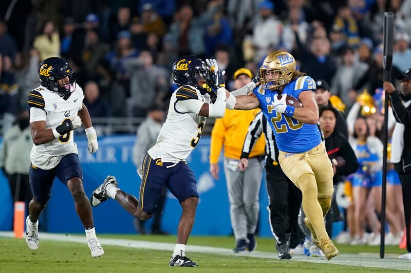 UCLA's Carsen Ryan, right, stiff-arms California defensive back Nohl Williams during game Saturday, Nov. 25, 2023, in Pasadena, Calif. The former Bruin will bring depth to the Utes' 2024 tight ends room in 2024.