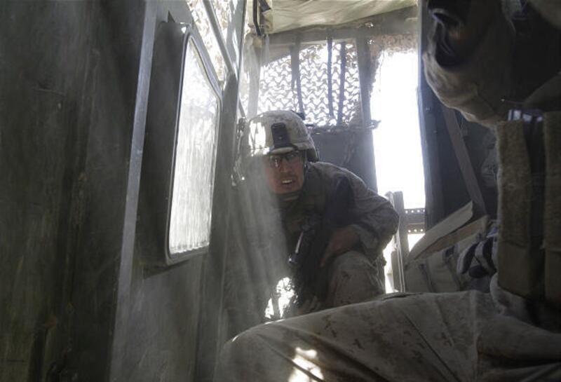 Marine Staff Sgt. Luke Medlin takes cover as a Taliban mortar explodes in Now Zad.