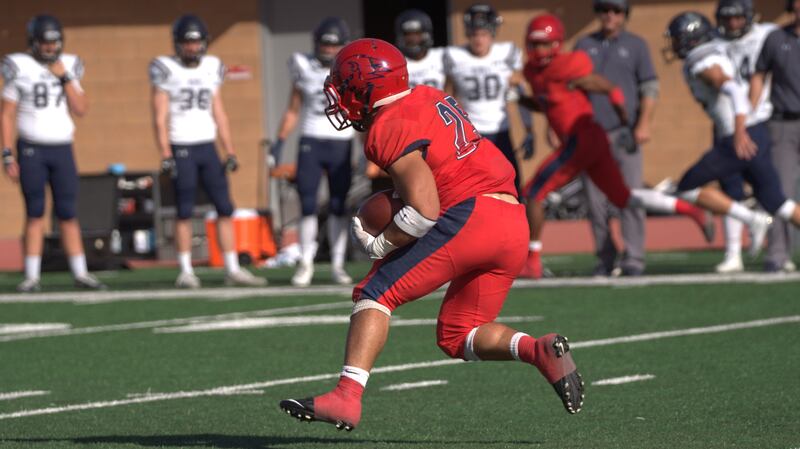 Dixie State running back Sei-J Lauago makes a run vs. Colorado School of Mines on Nov. 3. Lauago became the DSU career rusher leader in Saturday's 52-10 win over Adams State.