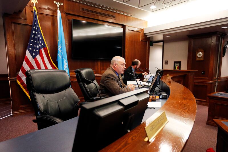 FILE - Commissioners Bill Lee, center, and Nathan Ivie participate in a commission meeting in Provo on Tuesday, Dec. 12, 2017. Since last spring, the Utah County Commission has weighed whether to establish a board to review allegations of misconduct by pr
