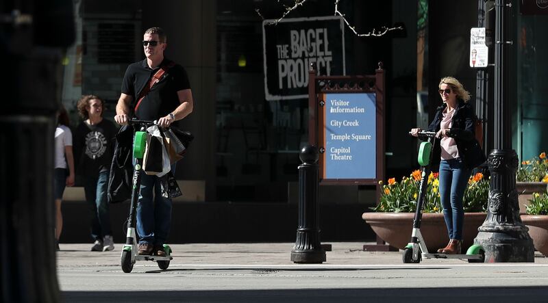 E-scooter renters ride down Main Street in Salt Lake City on Friday, April 19, 2019.
