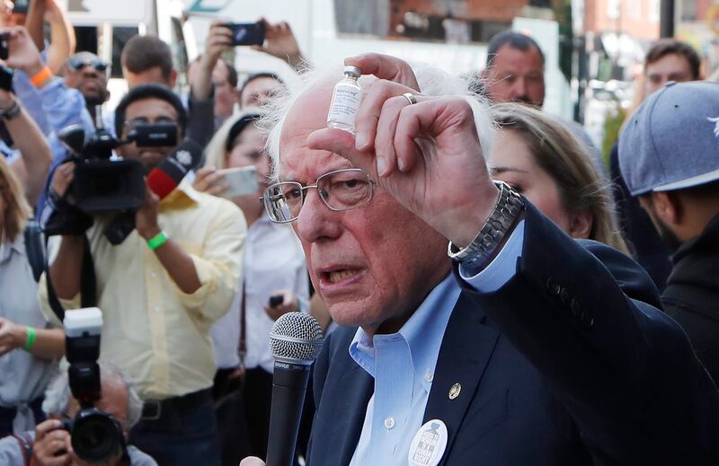 Democratic presidential candidate Sen. Bernie Sanders, I-Vt., holds an insulin vial as he addresses the media outside the Olde Walkersville Pharmacy, Sunday, July 28, 2019, in Windsor, Ontario. Sanders accompanied about a dozen people who purchased the dr