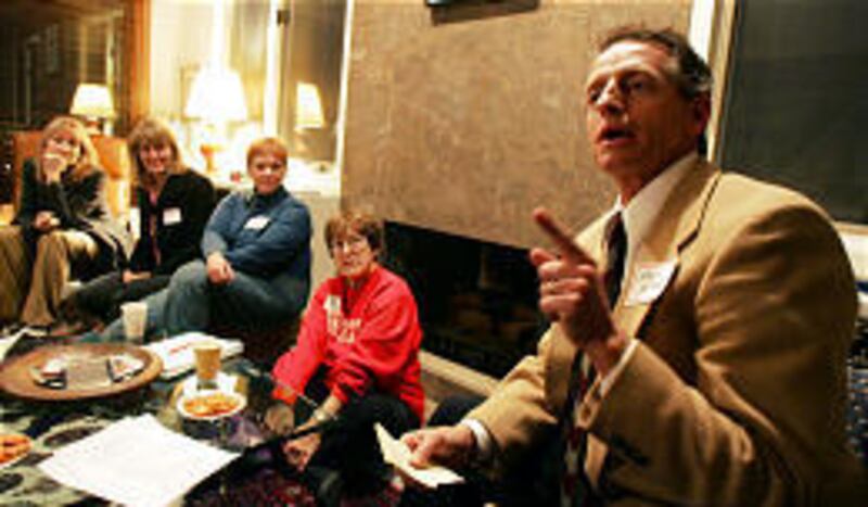 State Democratic Party Chairman Wayne Holland talks with fellow Democrats about plans and strategies for the 2006 election at a house party in Salt Lake Tuesday, one of 17 political house parties across the state.