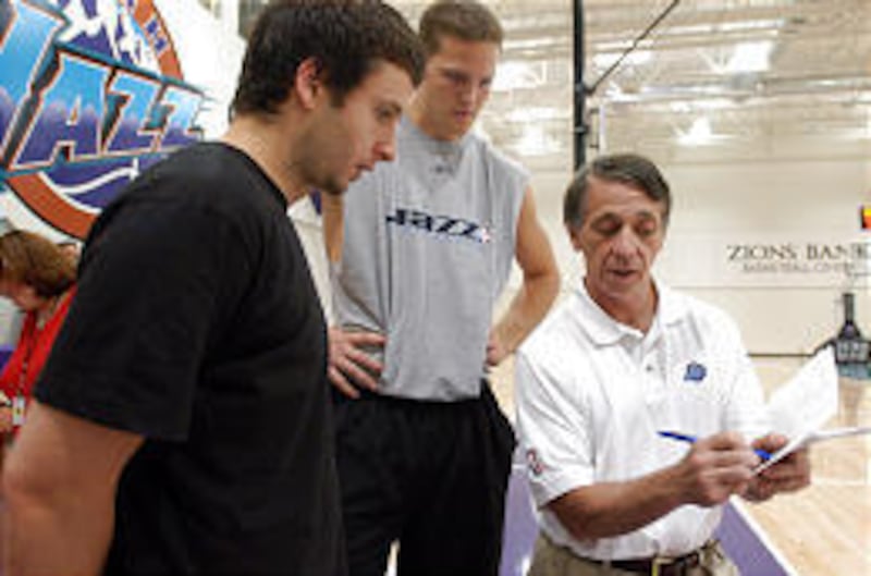 Jazz assistant coach Gordon Chiesa, right, goes over some plays with Raul Lopez, left, and Curtis Borchardt. Chiesa has been with Utah for 16 years.