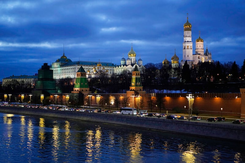Cars move in front of the Kremlin.
