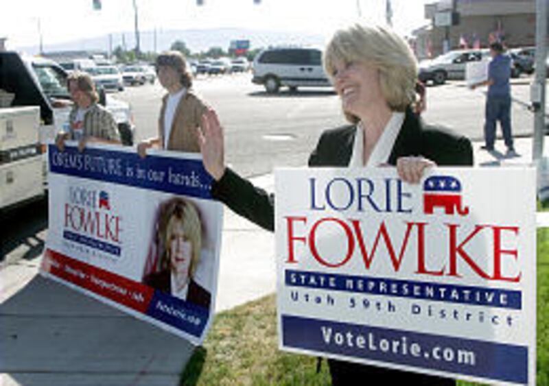 Lorie Fowlke, candidate for Utah House District 59, waves to potential voters from State Street in Orem.