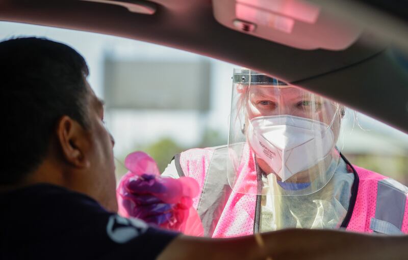 Megan Clay, a site lead, tests Joni Alvino for COVID-19 in West Valley City on Wednesday, July 6, 2022.