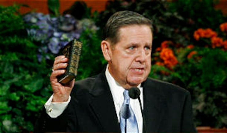 Elder Jeffrey R. Holland of the Quorum of the Twelve Apostles holds up the Book of Mormon studied by the Prophet Joseph Smith, during a general conference address on October 2009 general conference.