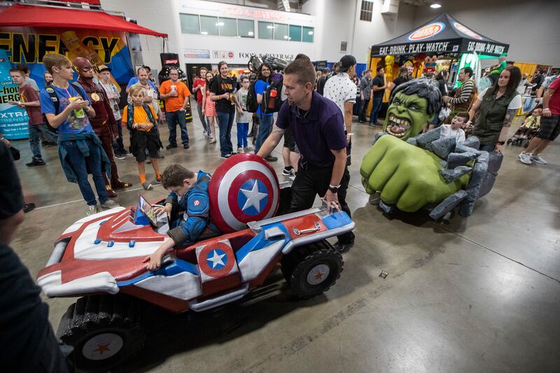 Scott and Crystal Shank push sons Braxden and Jayden in their new, specially built wheelchair costumes during the Fan XSalt Lake Comic Convention at the Salt Palace Convention Center in Salt Lake City on Friday, Sept. 7, 2018. Magic Wheelchair, a nonprofit