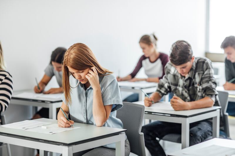 A group of high school students are pictured taking exam.