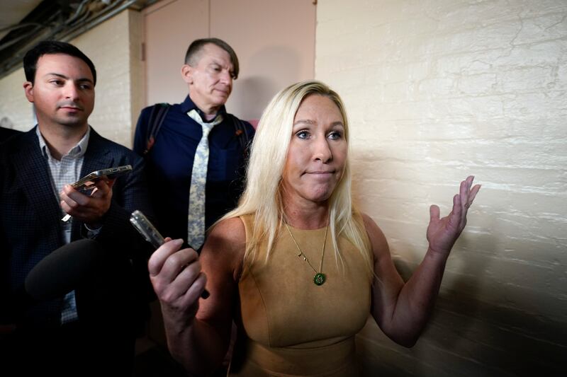 Rep. Marjorie Taylor Greene, R-Ga., arrives for the Republican caucus meeting in Washington on Oct. 19, 2023.