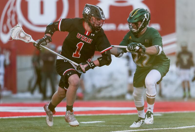 Utah’s Josh Stout carries a lacrosse stick