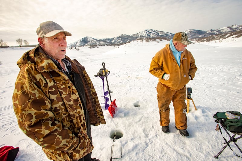 Bill Jensen and Ken Jensen brave the cold while ice fishing at Jordanelle State Park on Tuesday, Jan. 29, 2019.