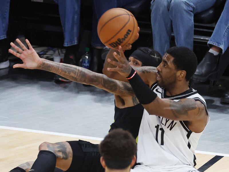 Utah Jazz guard Jordan Clarkson (00) and Brooklyn Nets guard Kyrie Irving (11) compete for the ball in Salt Lake City on Friday, Jan. 20, 2023. The Nets won 117-106.