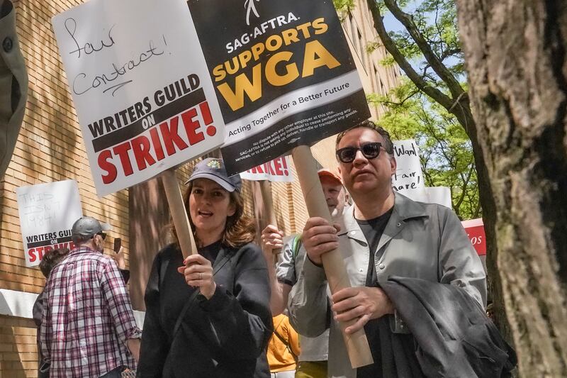 Tina Fey and Fred Armisen join striking members of the Writers Guild of America on the picket line during a rally outside Silvercup Studios.