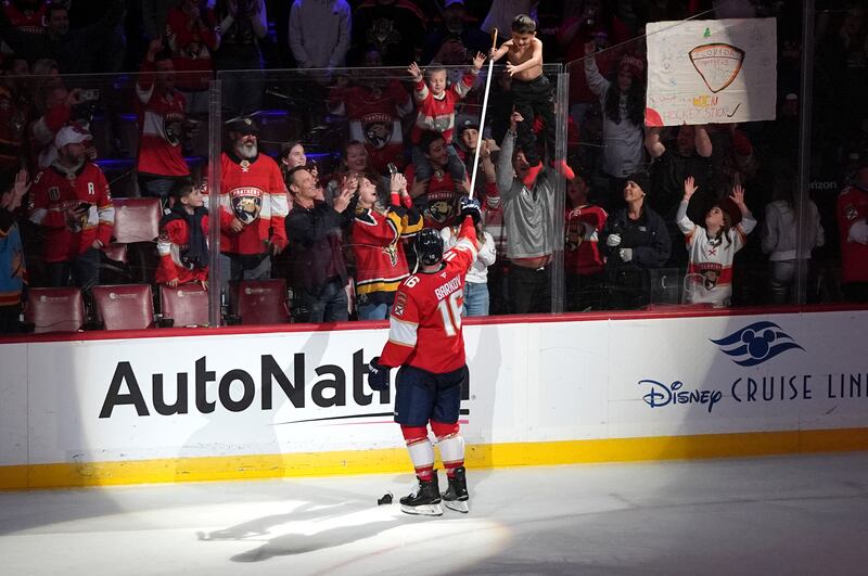 Florida Panthers center Aleksander Barkov (16) hands his hockey stick to a fan after being named the star of the game after a game against the St. Louis Blues, Friday, Dec. 20, 2024, in Sunrise, Fla.