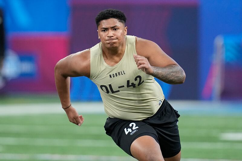 Utah offensive lineman Sataoa Laumea runs a drill at the NFL football scouting combine, Sunday, March 3, 2024, in Indianapolis.