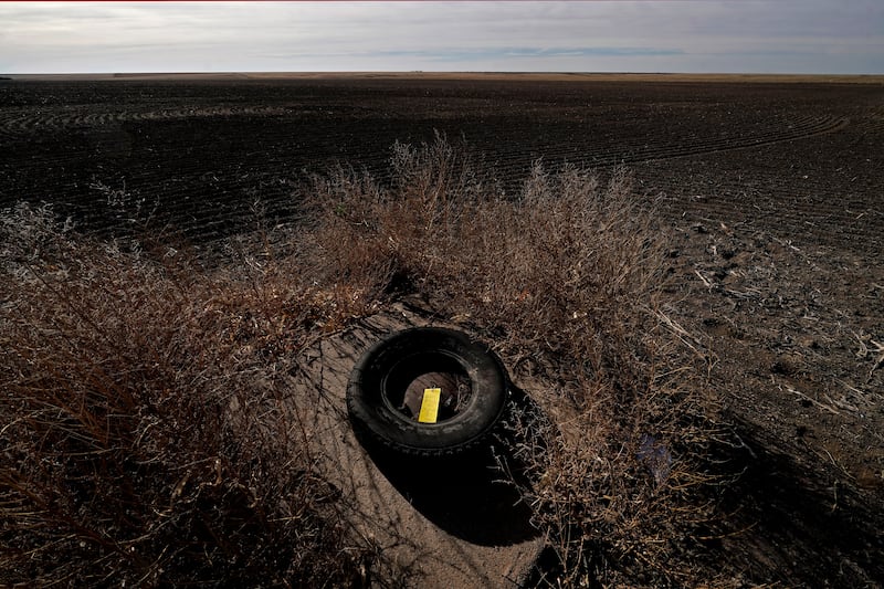 A yellow tag noting water levels is left on an unused irrigation well near Marienthal, Kan.