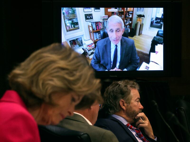 Senators listen as Dr. Anthony Fauci, director of the National Institute of Allergy and Infectious Diseases, speaks remotely during a virtual Senate Committee for Health, Education, Labor, and Pensions hearing, Tuesday on Capitol Hill in Washington
