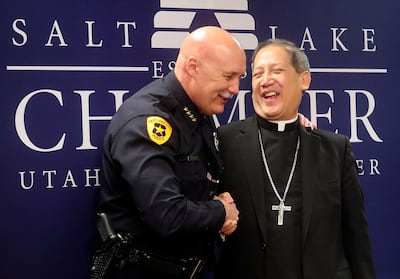 Salt Lake City Police Chief Mike Brown shakes hands with the Most Rev. Oscar Solis, bishop of the Catholic Diocese of Salt Lake City, after a press conference at the Salt Lake Chamber in Salt Lake City on Thursday, March 21, 2019, where community leaders