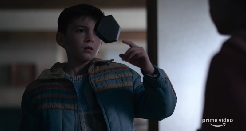 Cole, played by Duncan Joiner, examines a mysterious levitating rock in the trailer for “Tales from the Loop.”