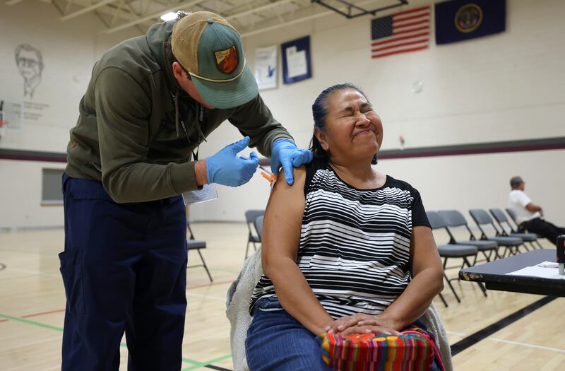 Ana Enriquez gets a Moderna COVID-19 booster shot at the Sanderson Community Center in Taylorsville.