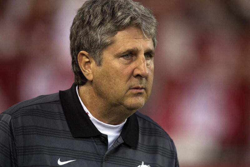 Washington State head coach Mike Leach watches Oregon warm up before the start of an NCAA college football game Saturday, Sept. 20, 2014, at Martin Stadium in Pullman, Wash. Oregon won 38-31. (AP Photo/Dean Hare)