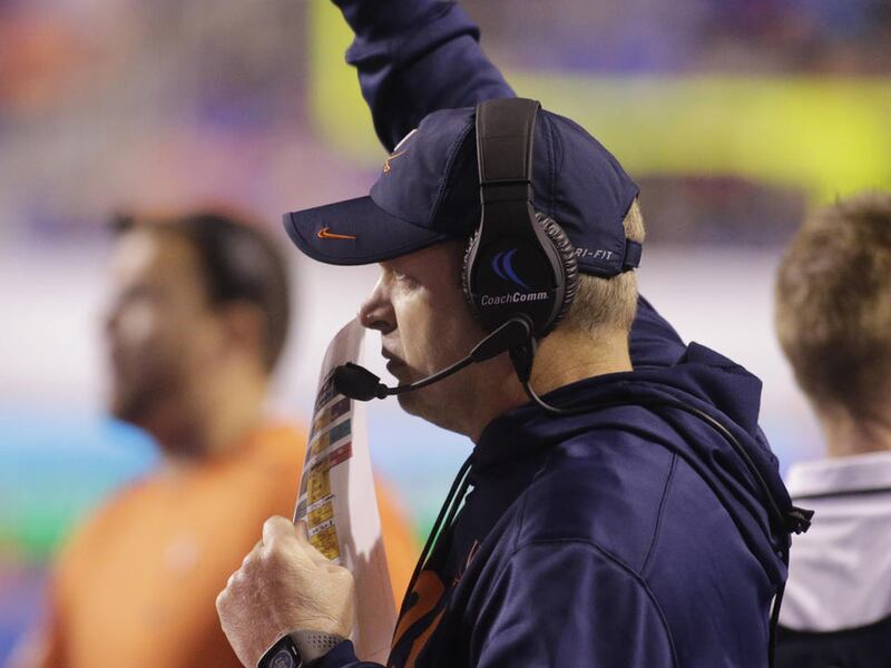 Virginia head coach Bronco Mendenhall sends signals to his team during the second half of an NCAA college football game against Boise State in Boise, Idaho, on Friday, Sept. 22, 2017. Virginia won 42-23. (AP Photo/Otto Kitsinger)