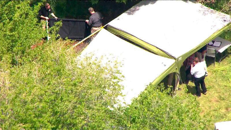 Police investigate a location on Center Street in Logan, Utah, as they search for the body of missing 5-year-old Elizabeth "Lizzy" Shelley on Wednesday, May 29, 2019. Earlier Wednesday, police charged Lizzy's uncle, Alexander William Whipple, 21, with cap