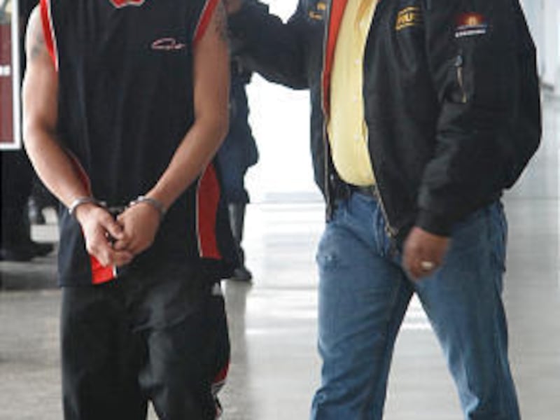 Venezuela's former lightweight boxing champion Edwin Valero, left, is escorted by a police officer to a police station in Valencia, some 150 kms west of Caracas, April 18, 2010.
