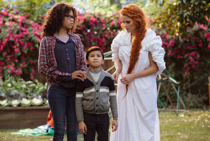 This image released by Disney shows Storm Reid, from left, Deric McCabe and Reese Witherspoon in a scene from “A Wrinkle In Time.” (Atsushi Nishijima/Disney via AP)