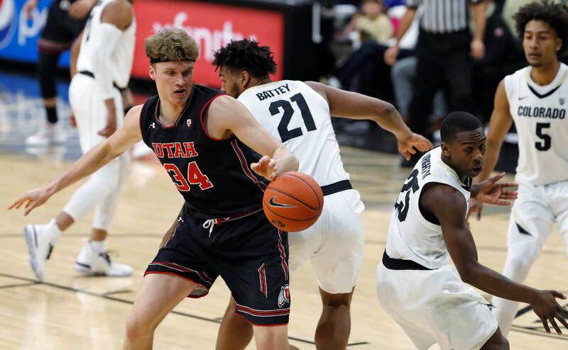 Utah center Jayce Johnson, left, and Colorado forward Evan Battey, center, and guard McKinley Wright IV look for the ball during the first half of an NCAA college basketball game Saturday, March 2, 2019, in Boulder, Colo. (AP Photo/David Zalubowski)