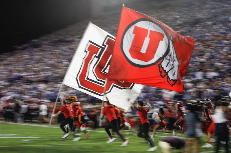 Utah Utes representatives fly the university flag as they compete against BYU in an NCAA college football game at LaVell Edwards Stadium in Provo on Saturday, Sept. 11, 2021.