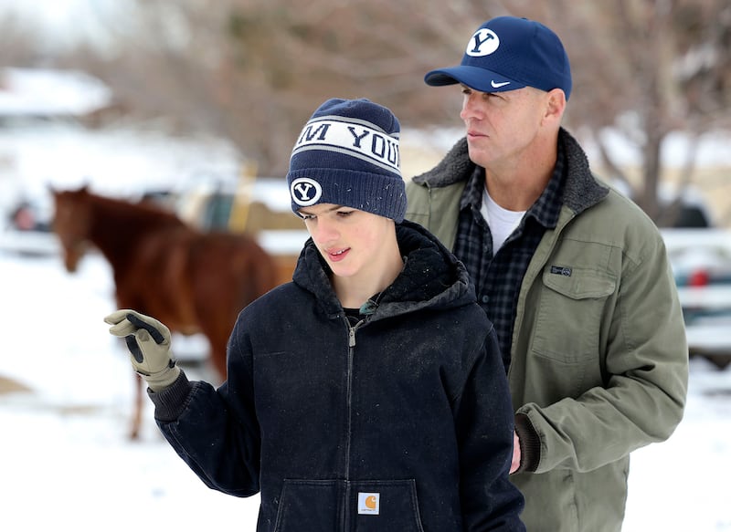 Edward Lamb and his father, BYU football assistant head coach Ed Lamb,d walk to their horses in Orem on Dec. 28, 2021.