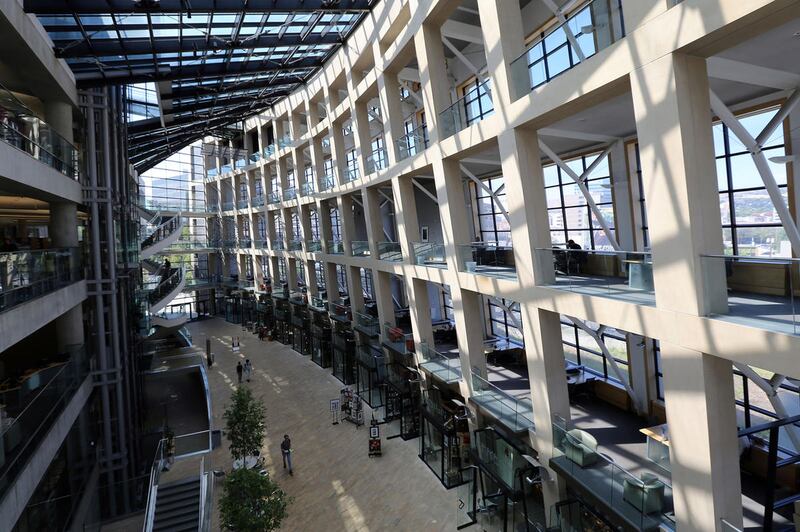 People walk through the atrium of the Salt Lake City Public Library in Salt Lake City on Monday, Aug. 22, 2016.