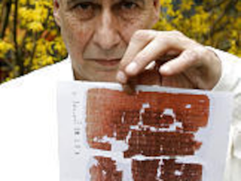 Mario Roberty displays a photo of a page of Judas document.
