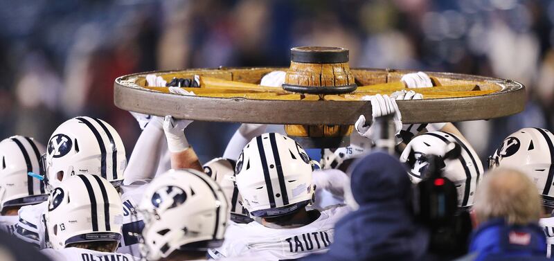 The BYU Cougars carry the Old Wagon Wheel after beating Utah State in 2015.