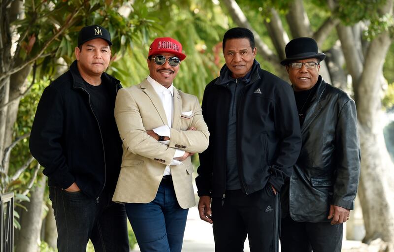 FILE - In this Tuesday, Feb. 26, 2019, file photo, Marlon Jackson, second from left, Jackie Jackson, second from right, and Tito Jackson, far right, brothers of the late singer Michael Jackson, and Tito's son Taj, far left, pose together for a portrait ou