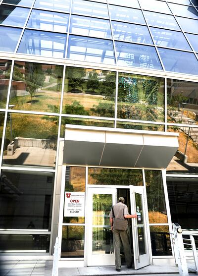 The University of Utah's upper campus is reflected in the glass entrance at the Health Sciences Education Building in Salt Lake City on Tuesday, July 17, 2018.