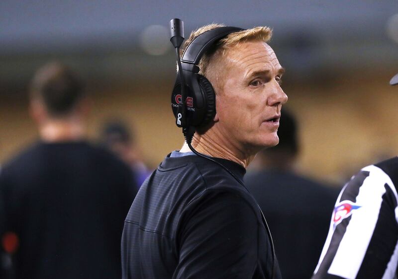 Utah State University football coach Blake Anderson talks with a referee on Friday Oct 1, 2021.