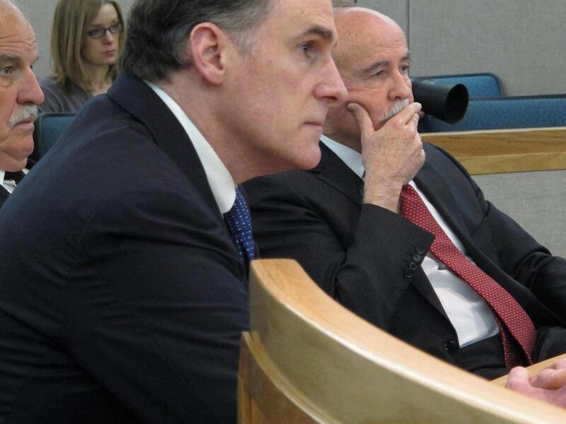 Former state lawmaker Bruce Weyhrauch listens to the judge during his sentencing hearing on Tuesday, March 15, 2011, in Juneau, Alaska. He is seated with his attorneys, Douglas Pope, rear, and Ray Brown, right. Weyhrauch was given a suspended three month