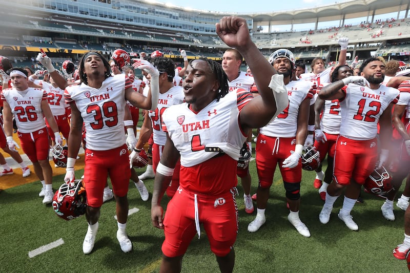 Utah running back Jaylon Glover celebrates with his team after defeating Baylor 20-13.