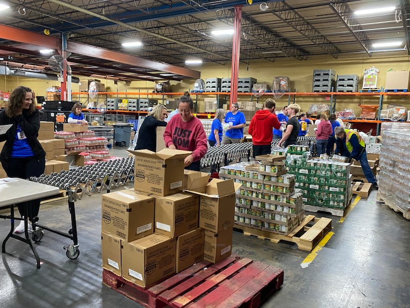 Volunteers help organize food donated by The Church of Jesus Christ of Latter-day Saints to Harvesters Food Bank in Kansas City, Missouri, on Thursday, April 23, 2026.
