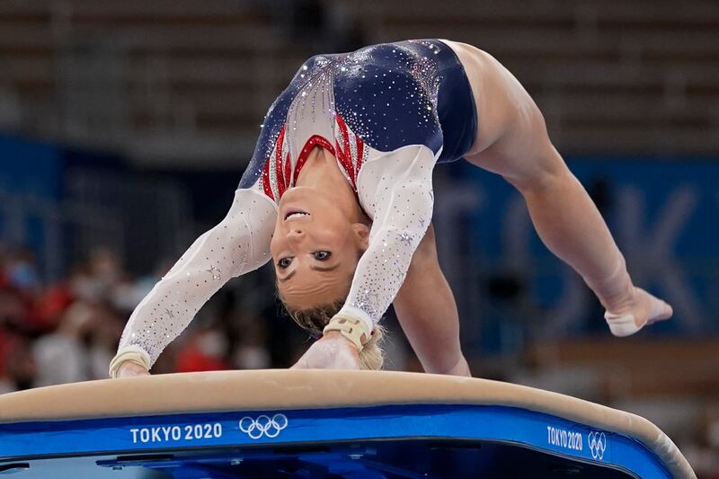 Gymnast Mykayla Skinner is twisted in a backbend with her arms on the vault as she performs during the artistic gymnastics women’s apparatus final at the 2020 Summer Olympics, Sunday, Aug. 1, 2021, in Tokyo, Japan.